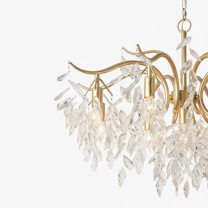 Detailed view of gold metal accents on a crystal chandelier.