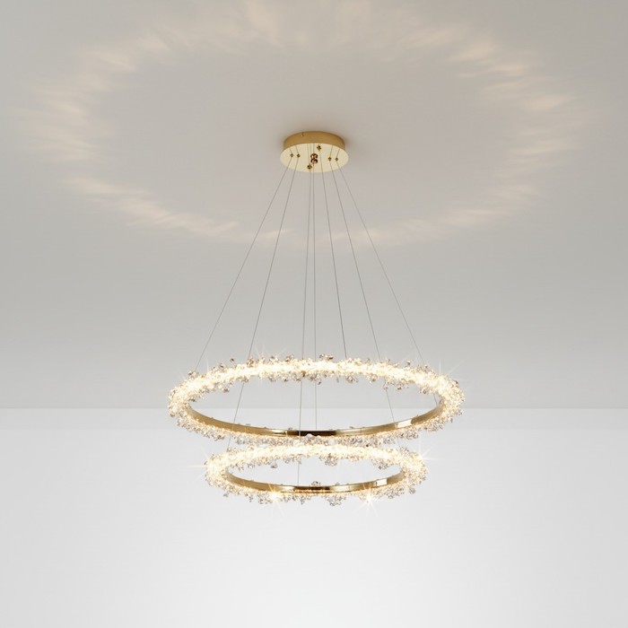Bottom view of a two-ring gold crystal chandelier showing intricate detailing.