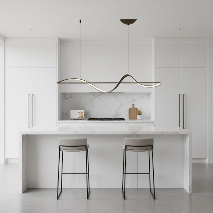 Horizontal symmetry of a linear chandelier over a white marble kitchen island.