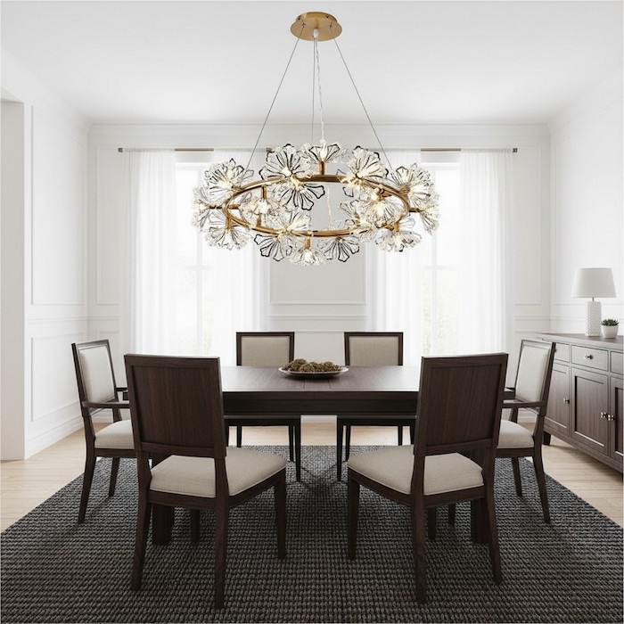 Airy crystal chandelier providing visual balance in a room with dark furniture.