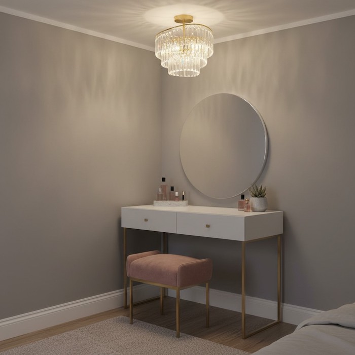 Elegant vanity area in a bedroom lit by a dedicated small crystal chandelier.