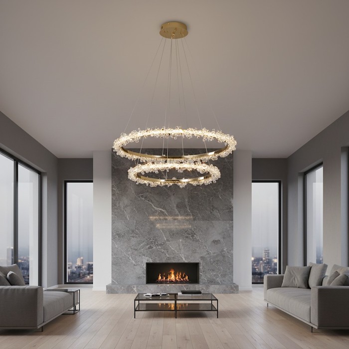 Luxury gold chandelier contrasting with a modern marble fireplace in a grand living room.