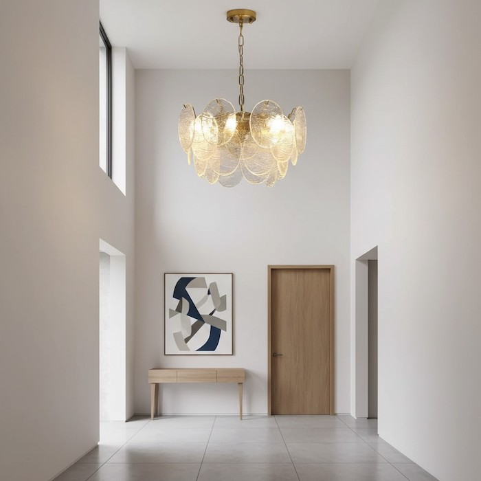 A sculptural wave chandelier providing a sense of arrival in a modern entryway.