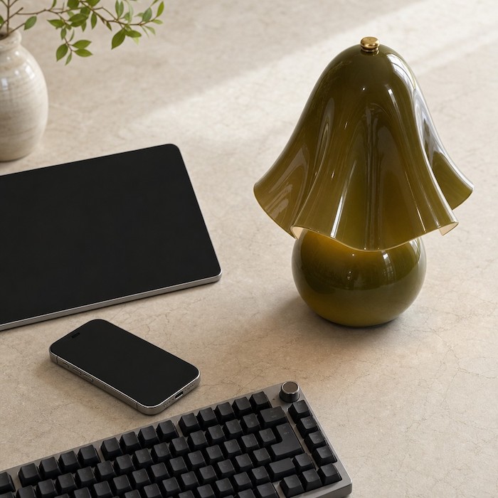 Organic sculptural lighting contrasting with modern office technology.
