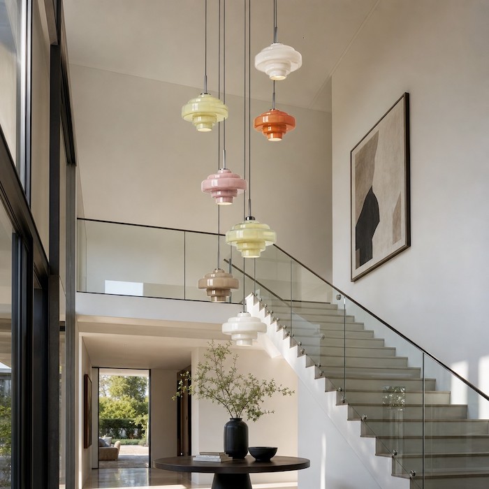 Cascading waterfall lighting effect in a high-ceiling entryway.