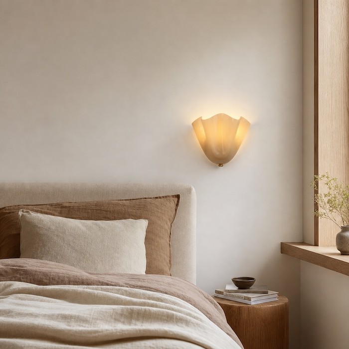 Bedside lighting alternative using a floral glass wall sconce.