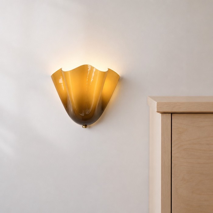 Contrast of brass wall sconce hardware and light birch wood.