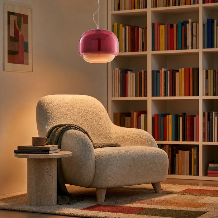 Atmospheric home library corner with warm amber and teal light filtering through colored glass.