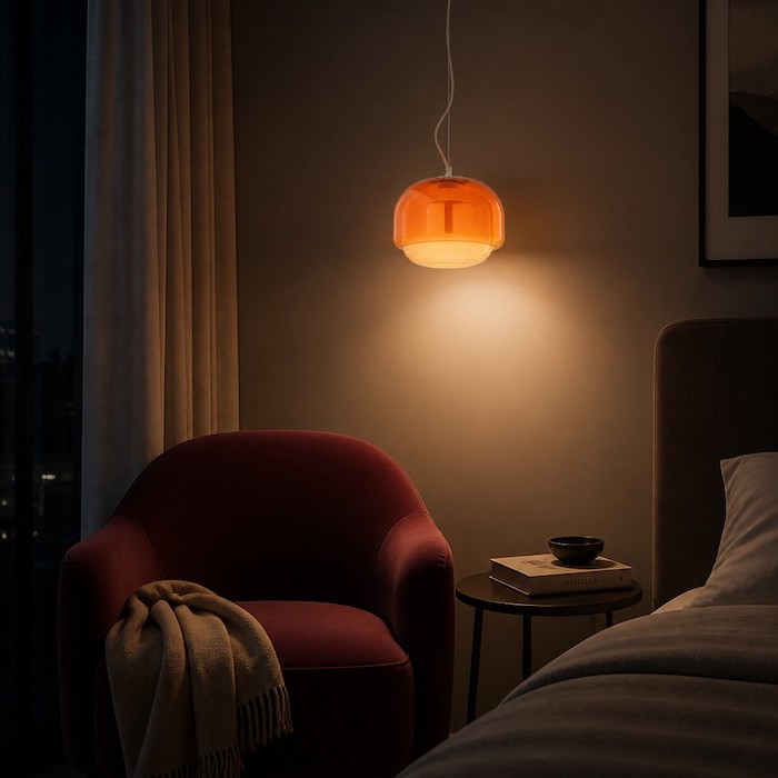 Serene nighttime reading nook illuminated by a vibrant spherical glass pendant lamp.
