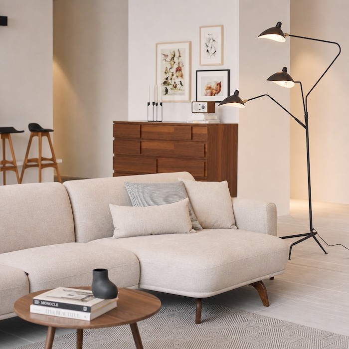 Multi-directional black metal floor lamp eliminating dark shadows in a spacious living room corner layout.