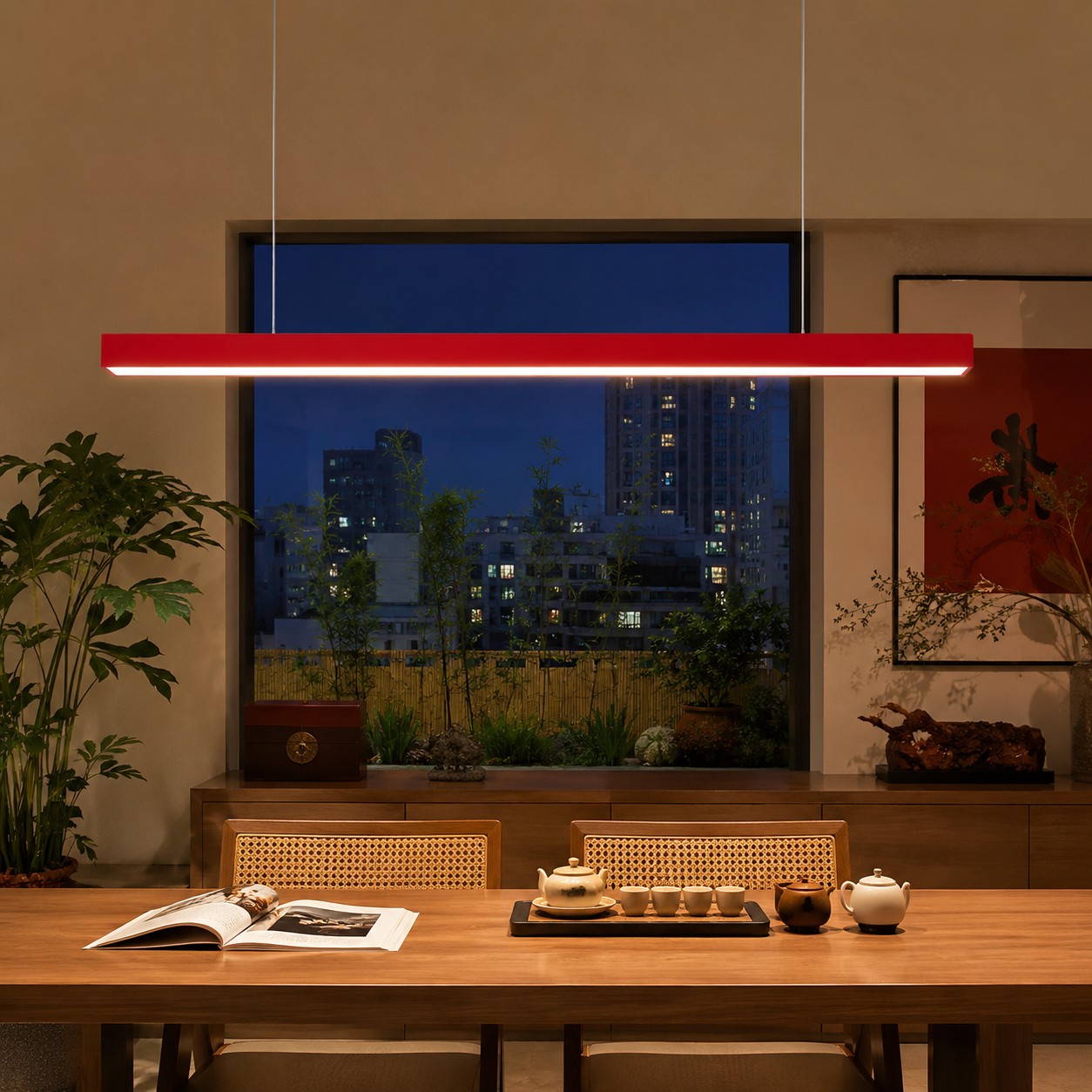 Red rectangular pendant organizing a quiet dining zone at night
