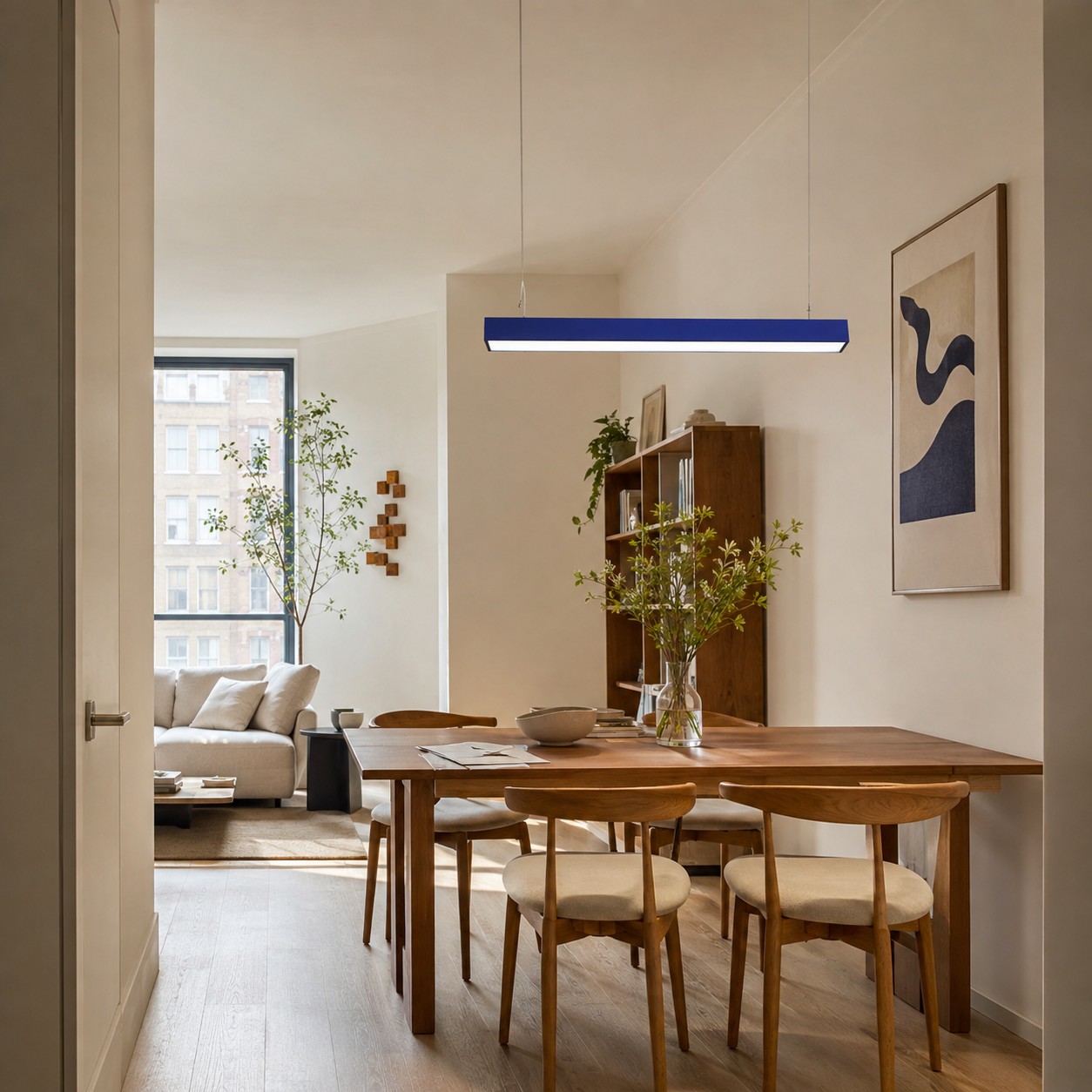 Blue rectangular pendant defining the dining zone from the main entrance