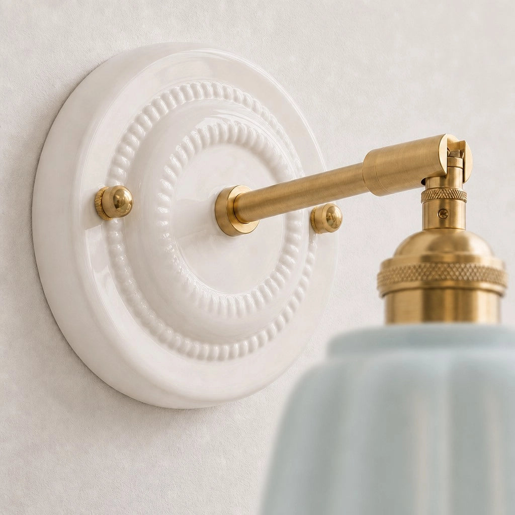 Embossed white ceramic wall plate and brass arm