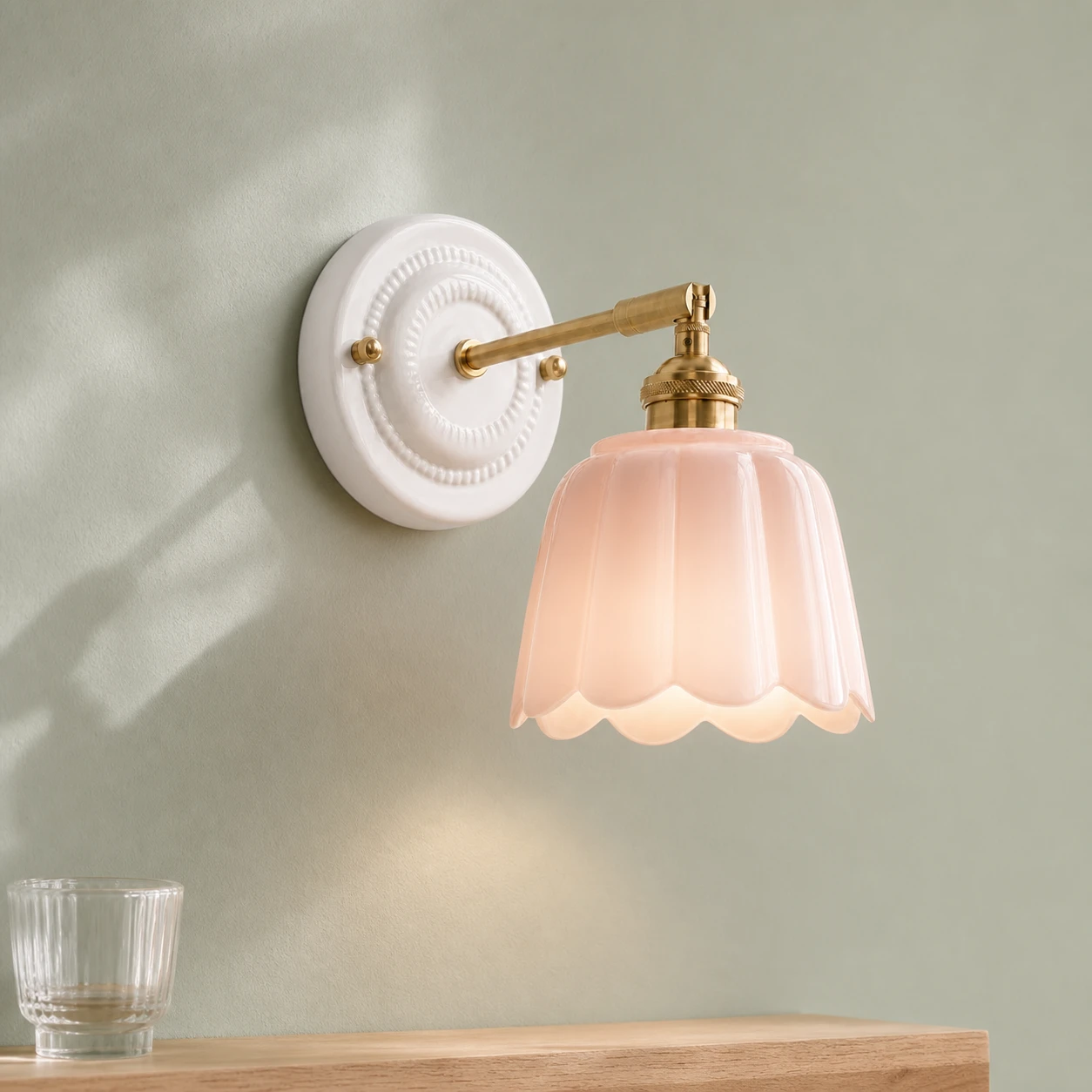 Pink wall light in a fresh sage colour setting