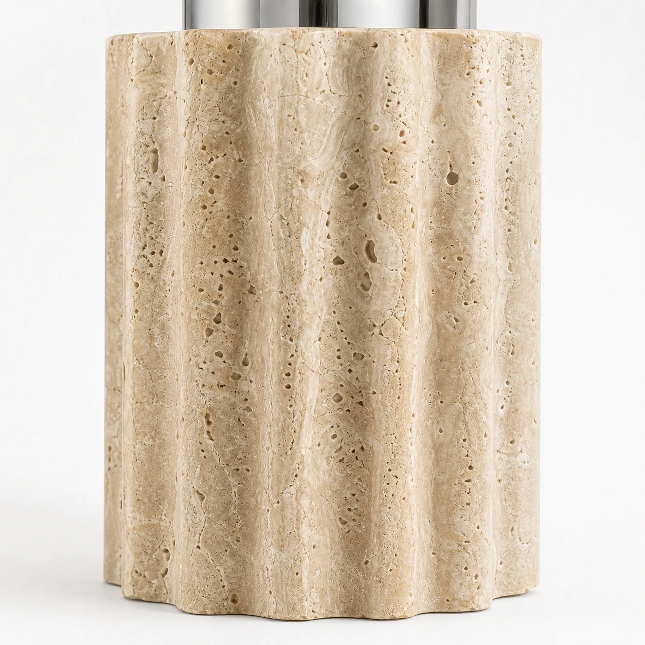 Close detail of the fluted natural travertine base