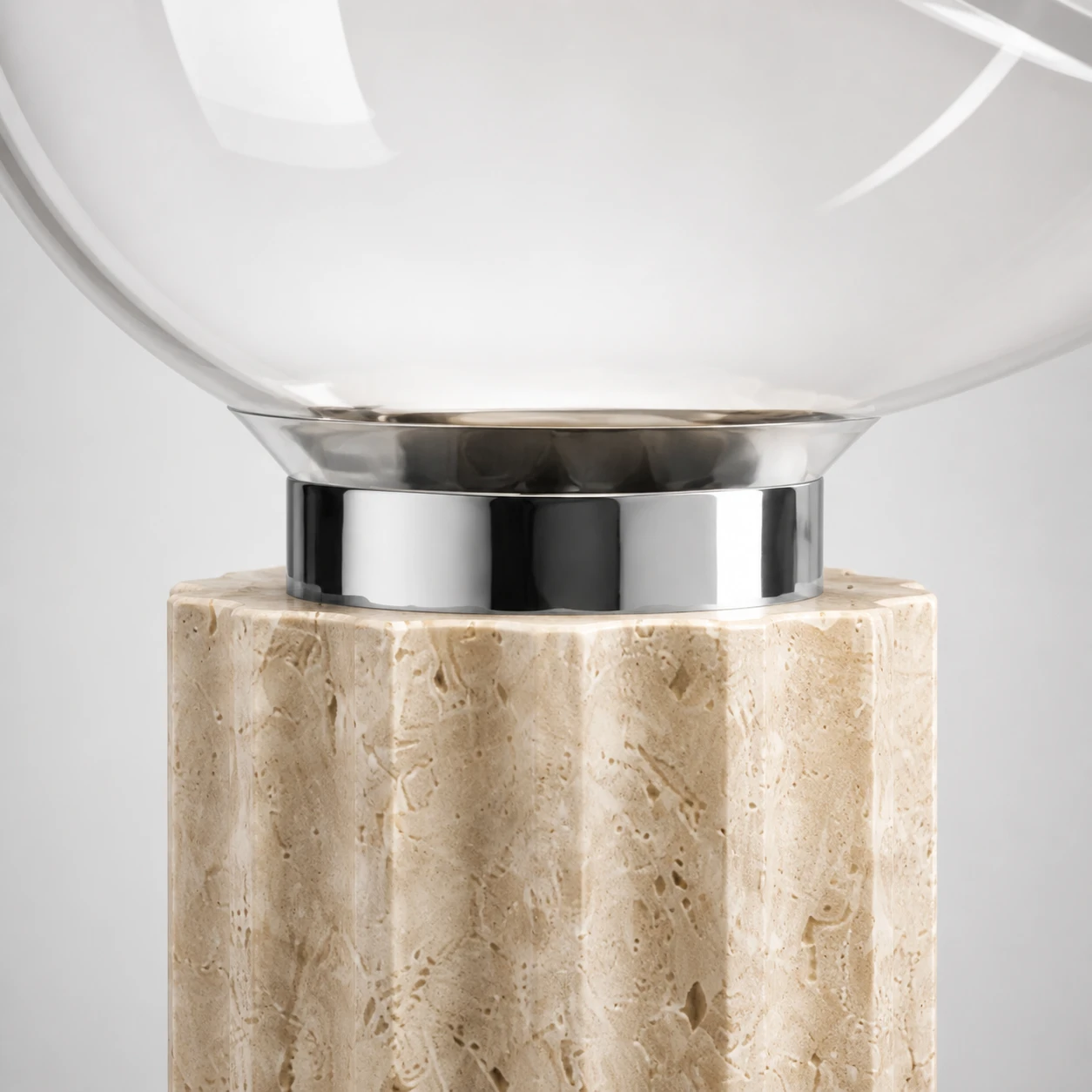 Close detail of the chrome and travertine connection