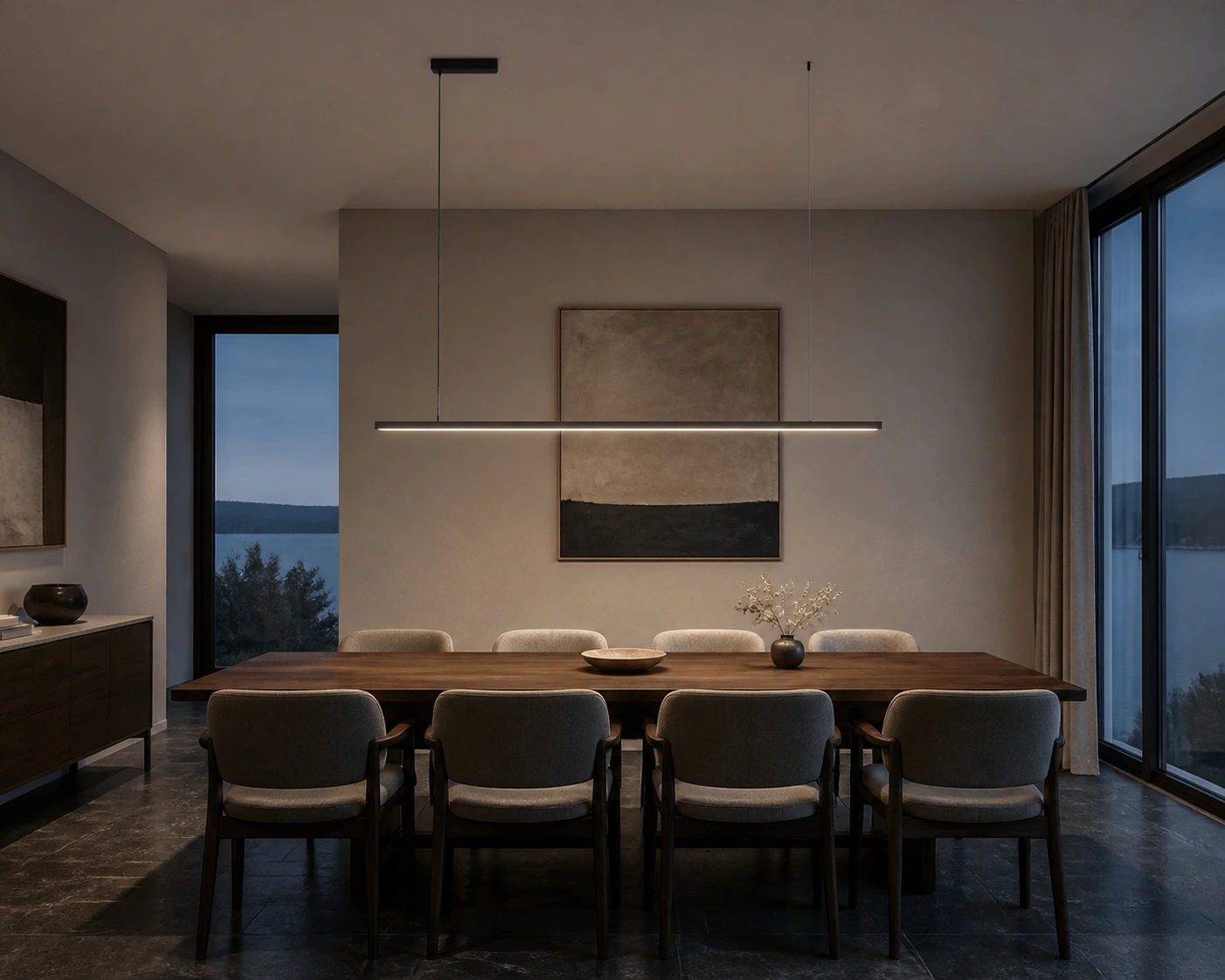 Edge linear pendant above a private hotel dining table at blue hour