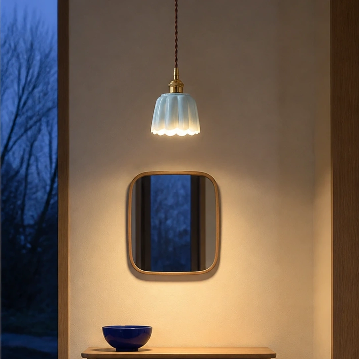 Blue Daphne pendant switched on in a Nordic entryway