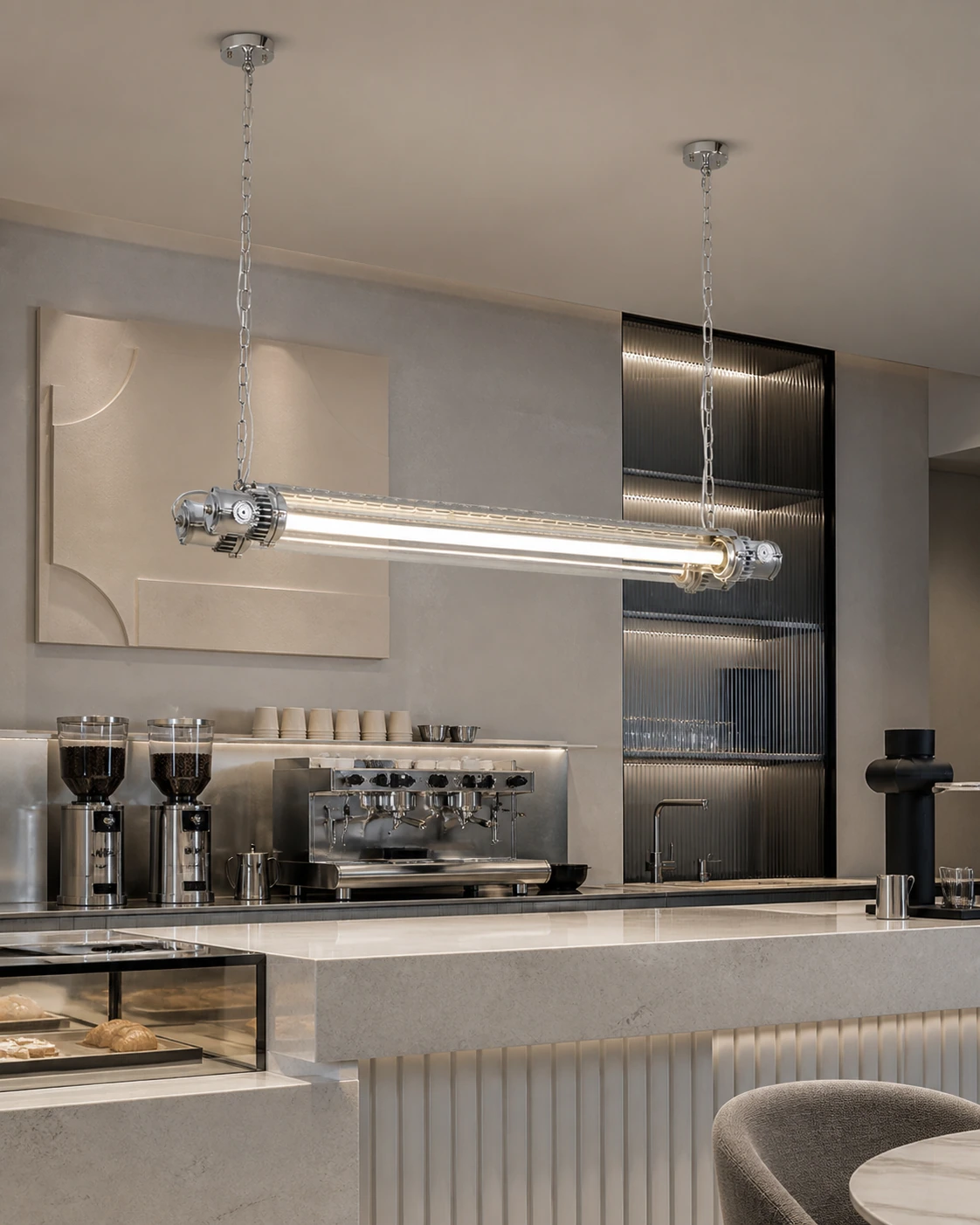 Double tube chandelier above a contemporary cafe counter