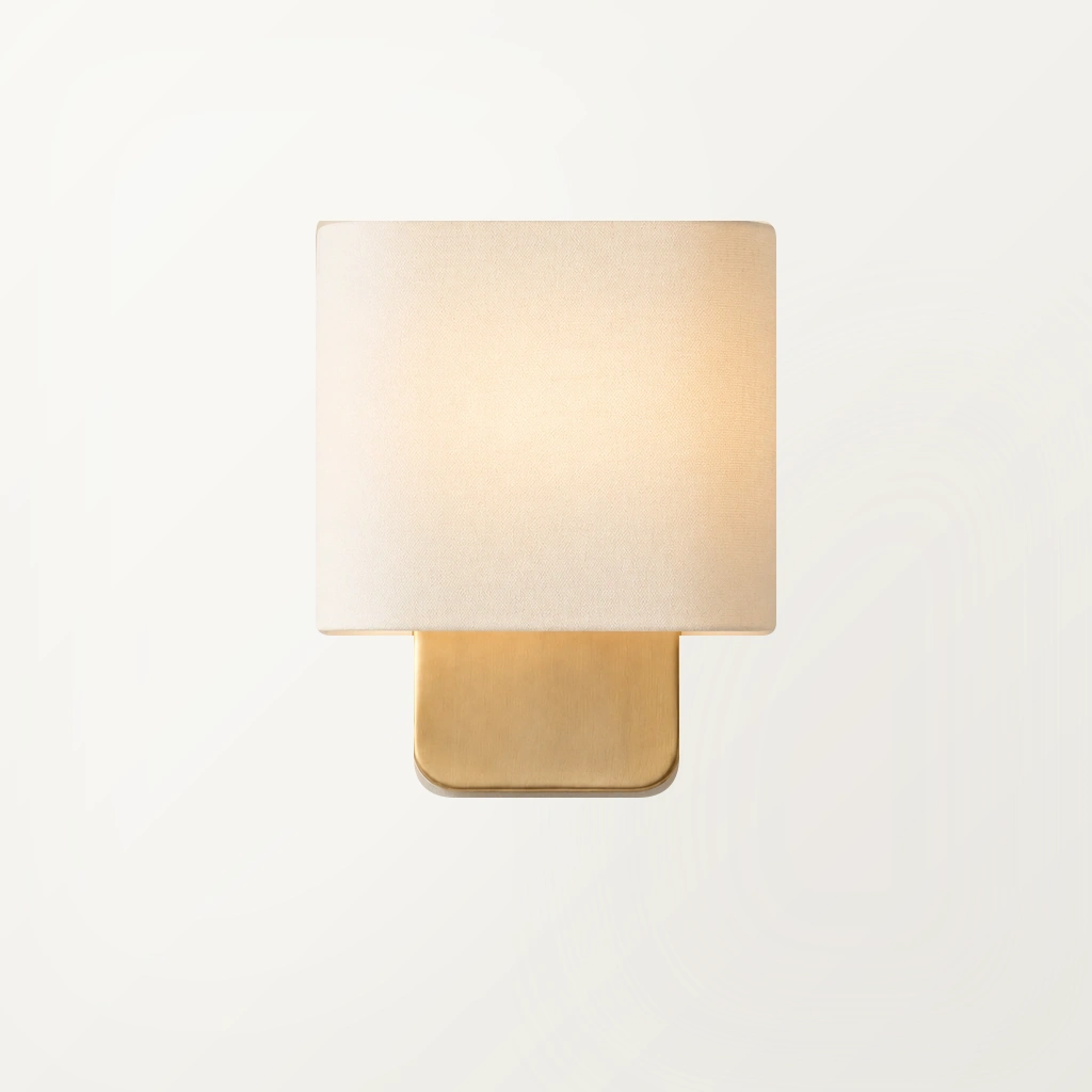 Close illuminated Jareth wall sconce on a clean warm-white plaster wall