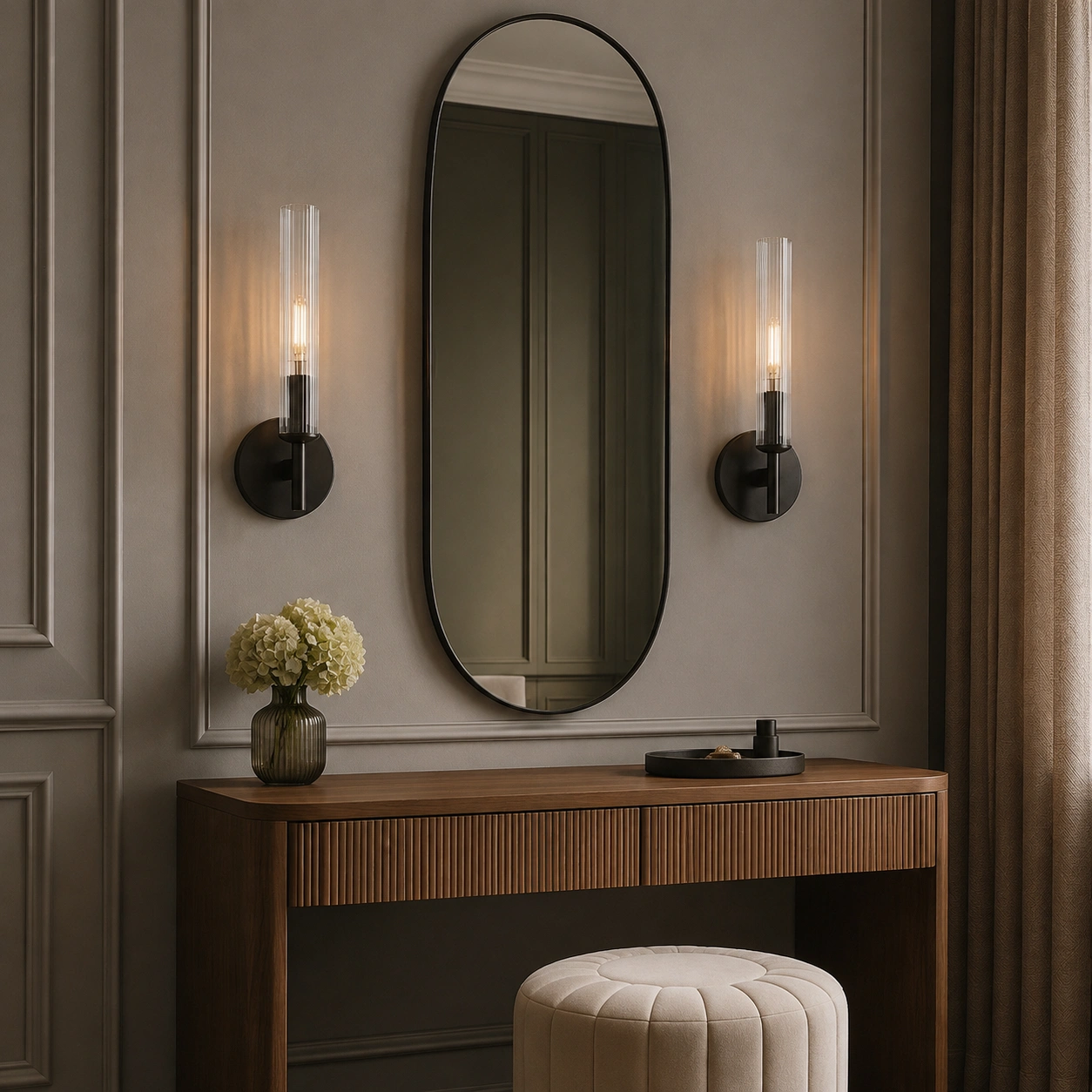 Paired bronze sconces beside a dressing mirror