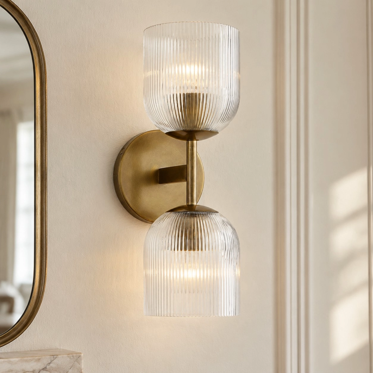Museia wall light in warm brass finish