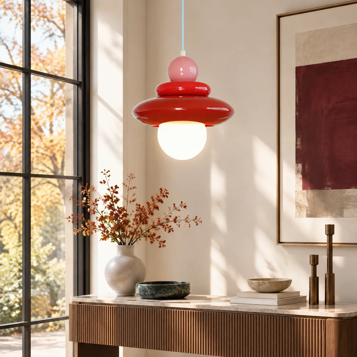 Compact Elara pendant glowing beside an autumn window
