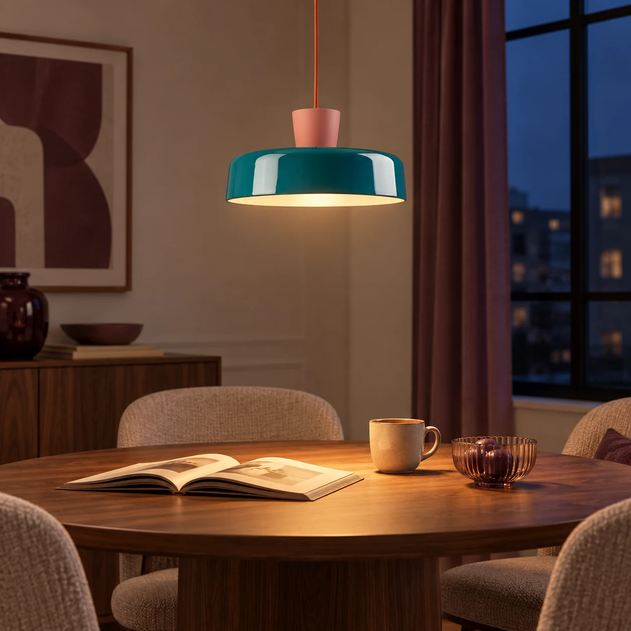 Suki pendant lamp glowing above an evening dining table