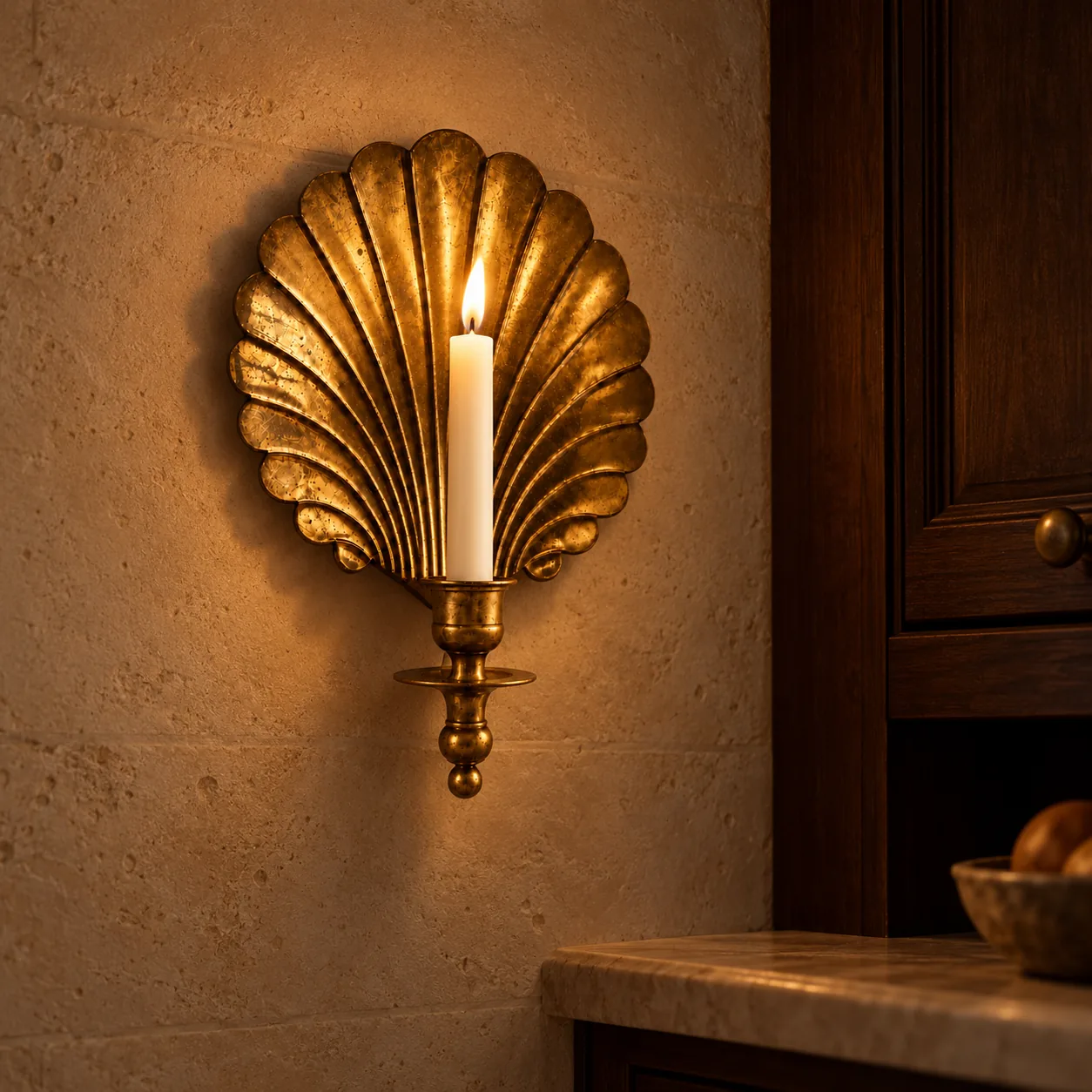 Lit shell sconce beside a kitchen cabinet